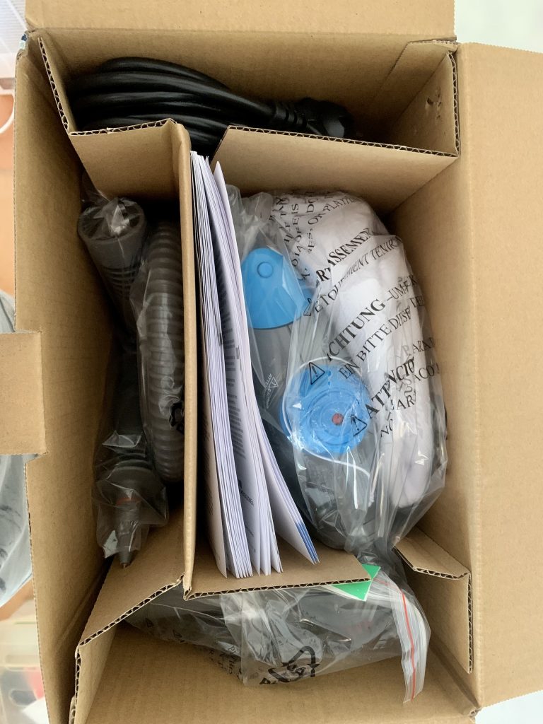 Bissell 2635J SteamShot Titanium Handdampfreiniger in geöffneter Verpackung