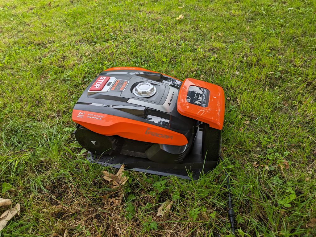 YARDFORCE COMPACT 300RBS Mähroboter auf der Wiese und in der Ladestation