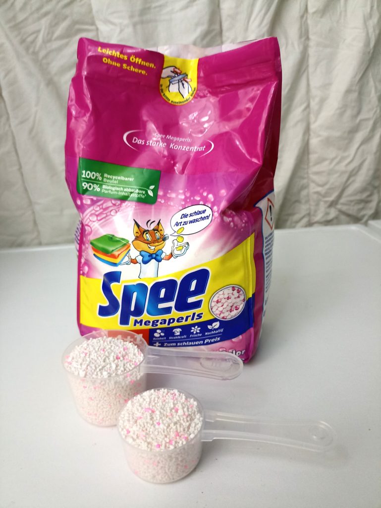 Spee Megaperls Color 4+1 Waschmittel, Verpackung Vorderseite mit dosiertem Waschmittel