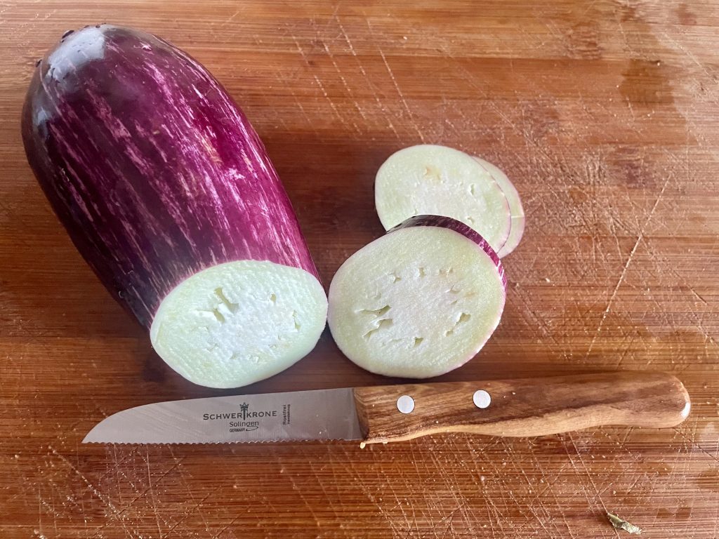 SCHWERTKRONE 1091 Küchenmesser beim Scheiden der Aubergine