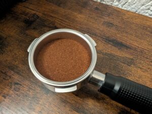 Kaffee-Pad der Krups Precision XP801T Siebträgermaschine mit gepressten Kaffe