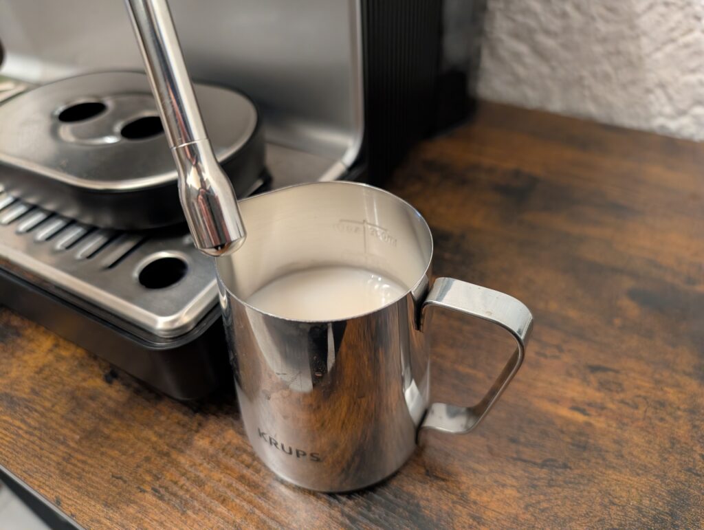 Milchkanne der Krups Precision XP801T Siebträgermaschine mit Milch