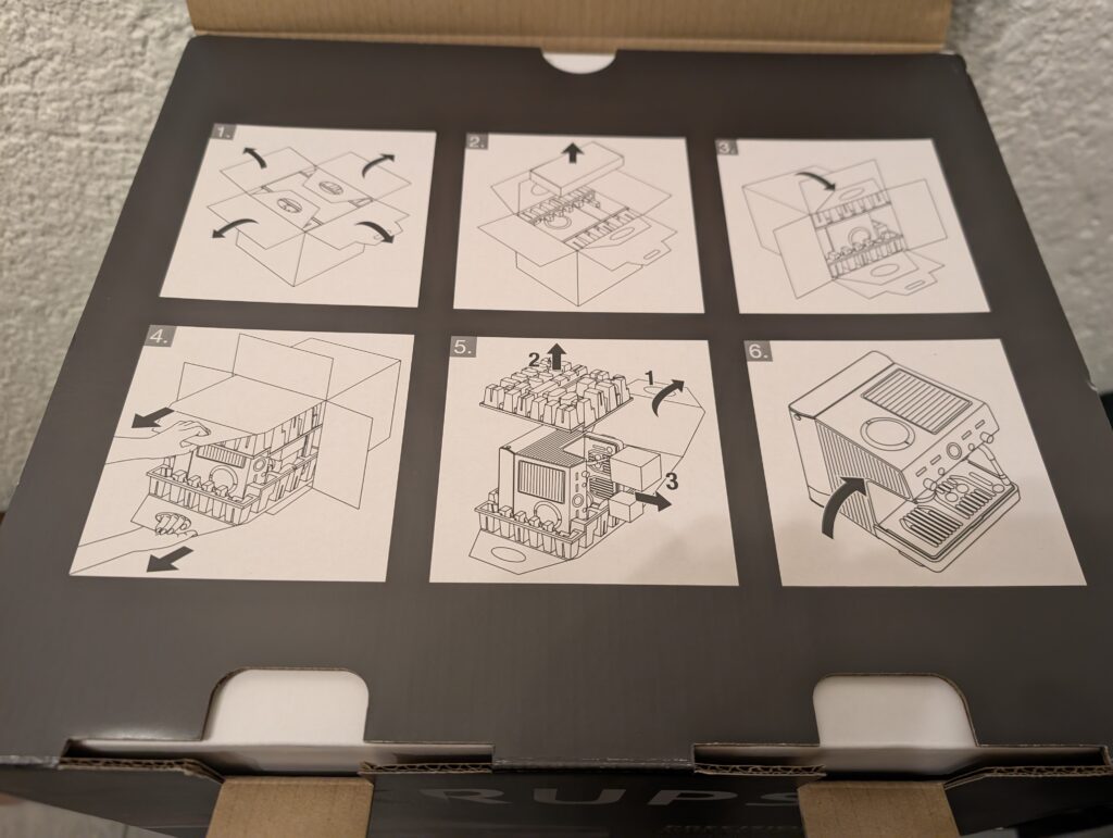 Verpackung der Krups Precision XP801T Siebträgermaschine teilweise geöffnet